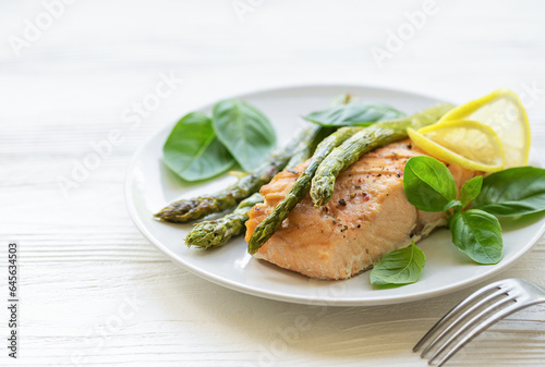 Baked Delicious salmon, green asparagus on plate