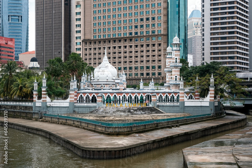View of Jamek Mosque at the confluence of the Gombak and Klang rivers on cloudy day. Kuala Lumpur, Malaysia.