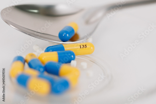 Macro Shot of colour Pills and Capsules During Production and Packing Process on Modern Pharmaceutical Factory. Tablet and Capsule Manufacturing Process. Close-up Shot of Medical Drug Production Line.