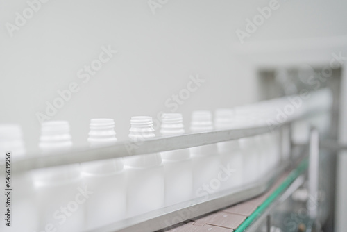 Close-up on liquid medicine  production and focus on Pills During Enema Production and Packing Process on Modern Pharmaceutical Factory.  Concept of Medical Drug Manufacturing Pharma business line.