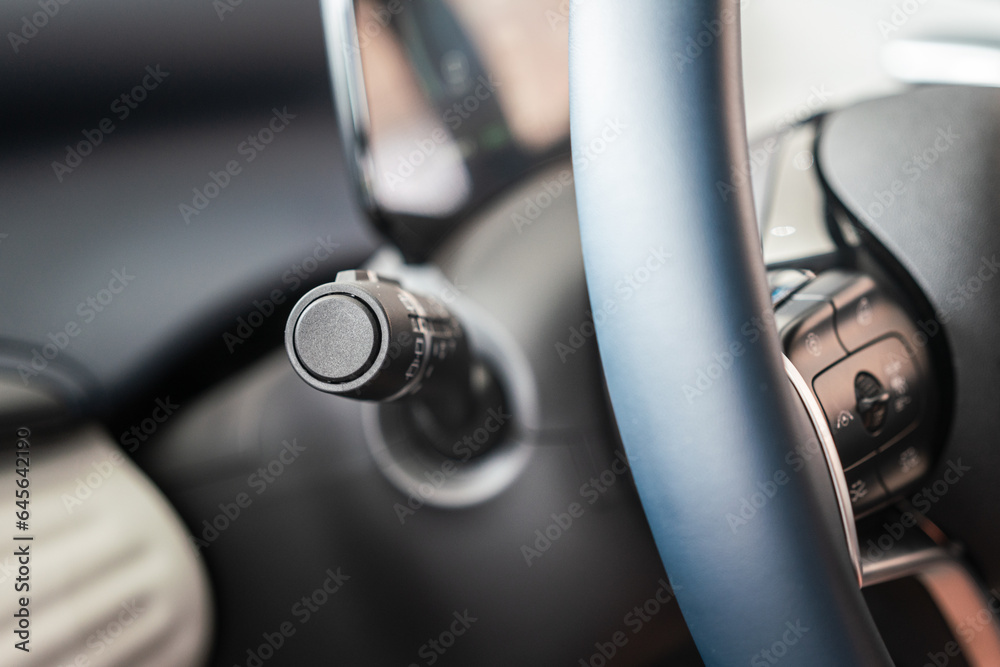 Close-up at car wheel handle lever for activate the raining wiper and turning lighting signal. Transportation and vehicle part equipment object, selective focus.