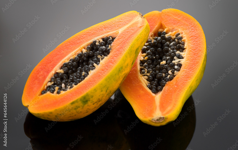 Papaya fruit on black background. Fresh organic Papaya exotic fruits close up. Healthy vegan papayas Papaya fruit on black background. Fresh organic Papaya exotic fruits close up. Healthy vegan papayas
