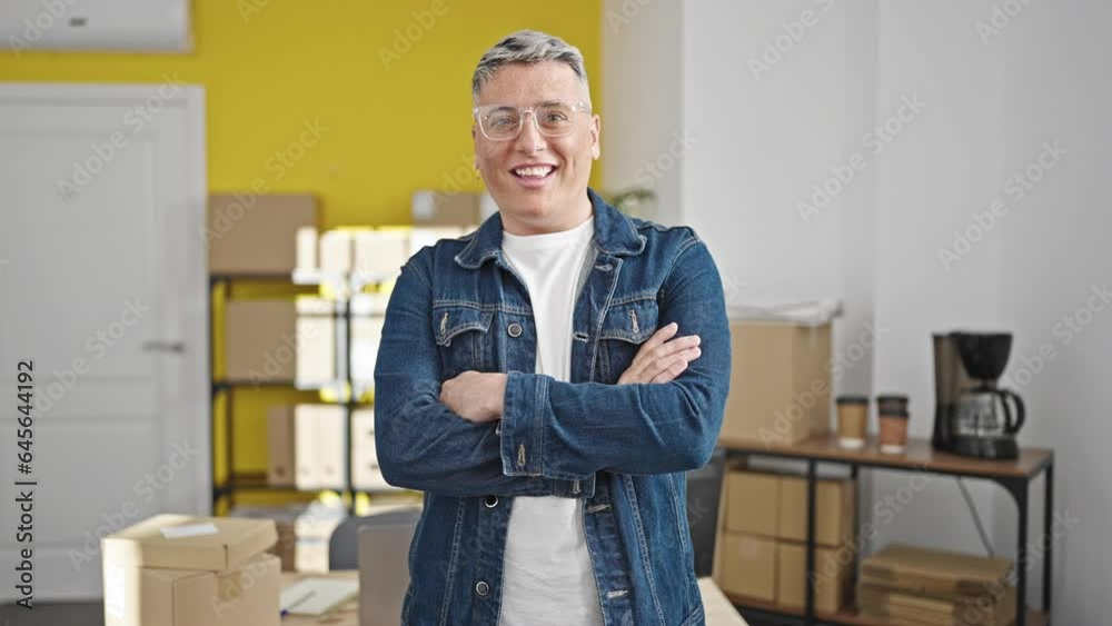 Young caucasian man ecommerce business worker standing with arms crossed gesture at office