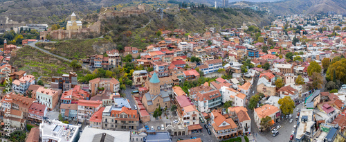 Panoramic aerial view of Old town, Narikala Fortress and St. George Cathedral on cloudy day. Tbilisi, Georgia.
