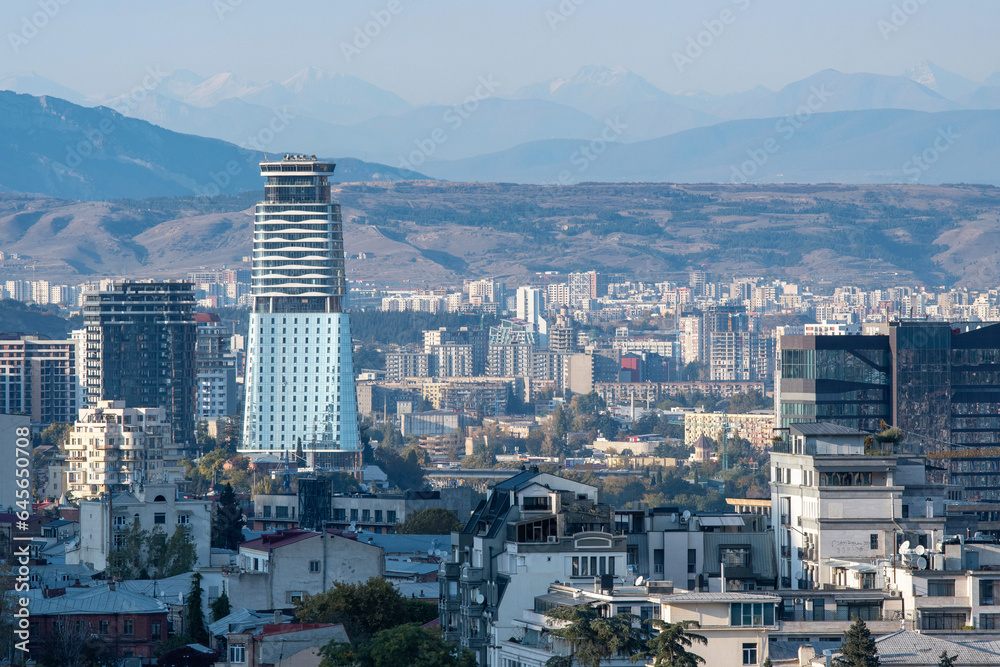 View of Tbilisi on the background of Caucasus Mountain Range on sunny autumn day. Georgia.