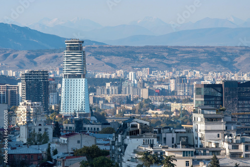 View of Tbilisi on the background of Caucasus Mountain Range on sunny autumn day. Georgia.