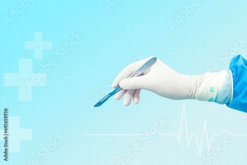 Doctor's hand holding a scalpel Background image of a doctor's hand holding a scalpel