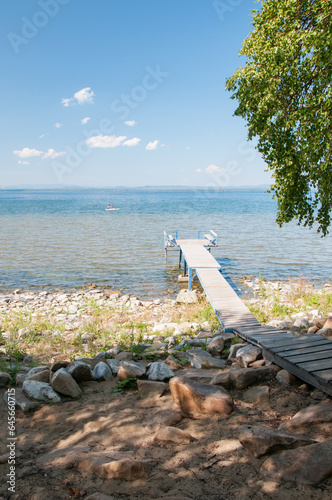 Lake Uvildy in summer with a wooden pier on the beach, South Urals, Russian Federation photo