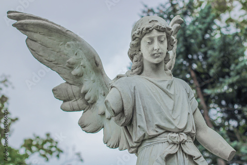 Sad antique statue in a cemetery