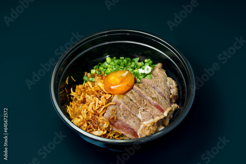 Grilled beef, Pickled eggs with soy sauce and fried garlics served with cooked rice on table. Clean food concept. Selective focus and free space for text.