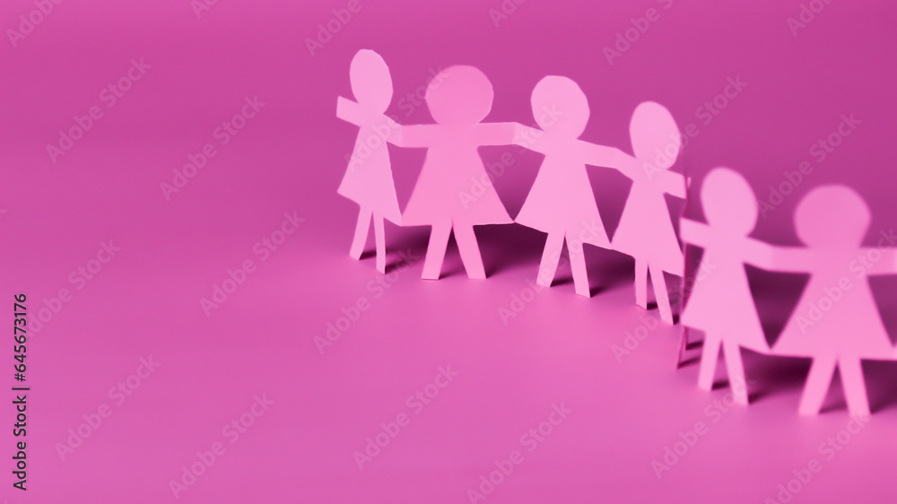 Pink woman paper on pink background to engourage breast cancer awareness symbolic bow raising support on a people living with women's breast tumor illness. Pink woman paper on pink background to engourage breast cancer awareness symbolic bow raising support on a people living with women's breast tumor illness.