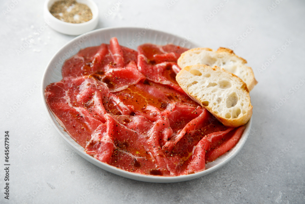 Traditional beef carpaccio with baguette bread