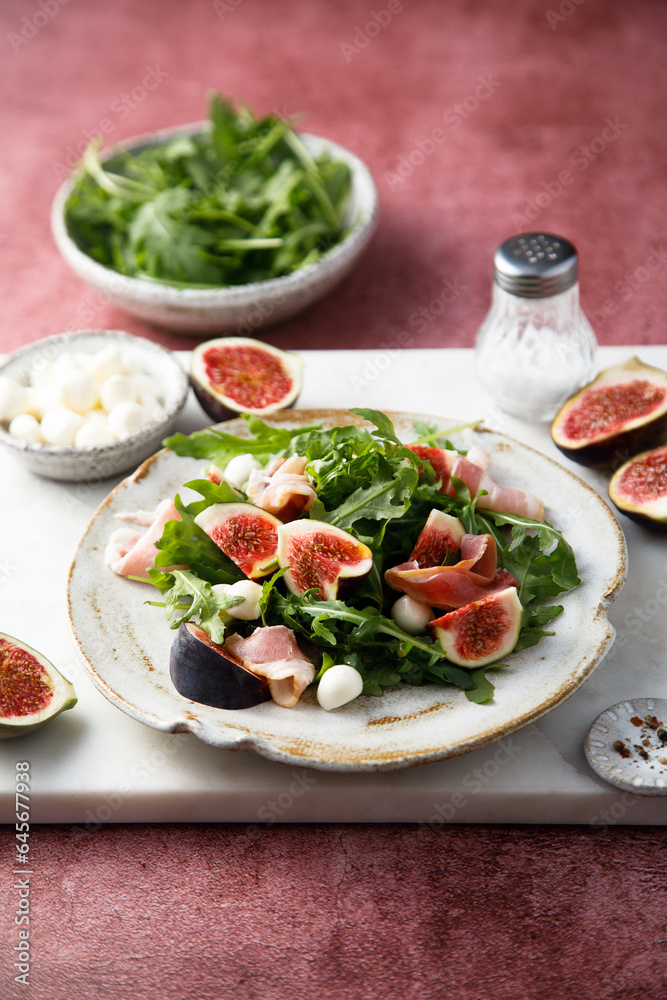 Arugula salad with figs and mozzarella cheese Arugula salad with figs and mozzarella cheese