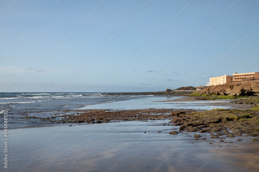 Morning views of Playa de la Jaquita, tranquil empty beach with volcanic sand near El Medano, coastal town visited by tourists for watersports and various activities, Tenerife, Canary Islands, Spain Morning views of Playa de la Jaquita, tranquil empty beach with volcanic sand near El Medano, coastal town visited by tourists for watersports and various activities, Tenerife, Canary Islands, Spain