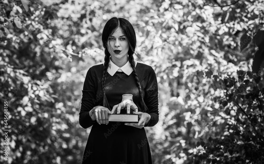 Goth girl with long black hair, Halloween party ideas, cosplay and spooky costume Stock Photo