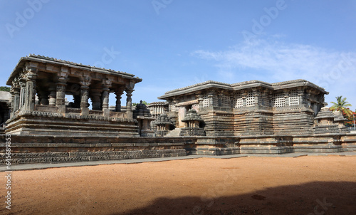 An Overview of the 'Hoysaleshwara' stone temple dedicated to Lord Shiva against the blue sky at Halebeedu in Karnataka, India. photo