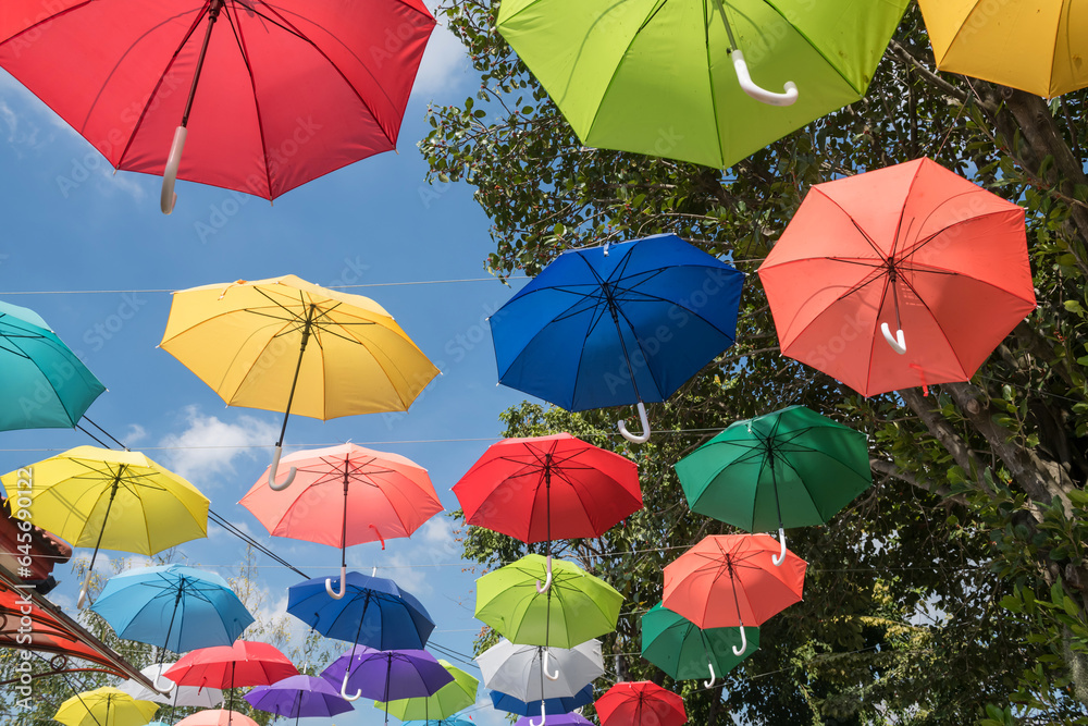 colorful umbrellas hanging on rope to decor outdoor