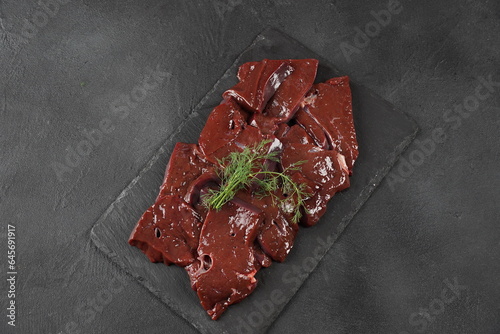 Fresh Raw beef liver on a slate board photo