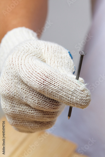 man in white gloves with nails