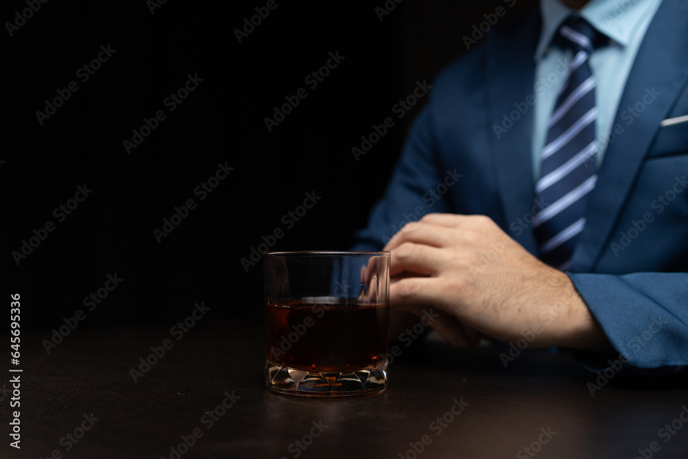 Man with glass of whiskey, businessman drinking whiskey in dark room, drinking alcohol drunk, businessman stress. Intoxicated drink concept. Man with glass of whiskey, businessman drinking whiskey in dark room, drinking alcohol drunk, businessman stress. Intoxicated drink concept.