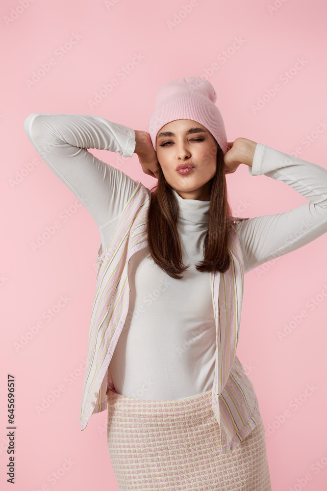 Happy playful young woman in pink hat, shirt and skirt Happy playful young woman in pink hat, shirt and skirt