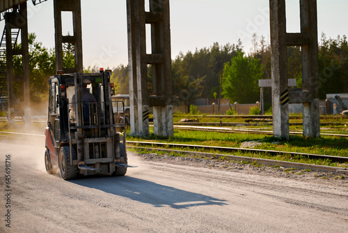 Forklift drives about silica factory area on sunny day