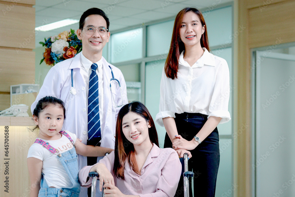 Obraz premium Female Asian patient in wheelchair with family come to hospital, be taken care by senior male doctor at medical clinic, happy patient feels better after treatment, medical consulting with professional