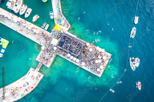 Beach party on pier aerial view photo