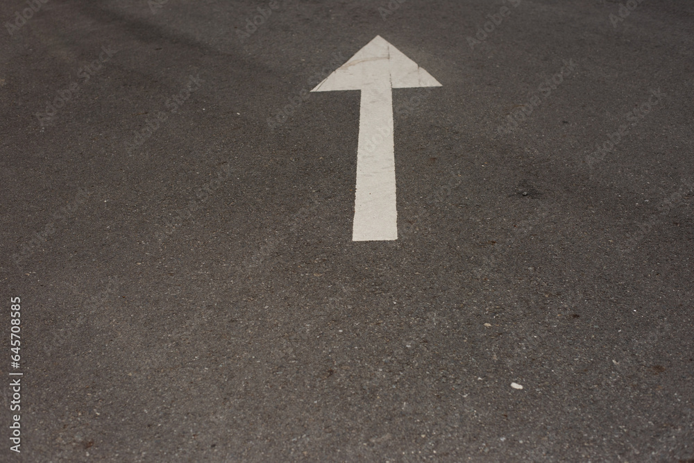 The white arrow on the road surface is an enlightening path, by universal principles