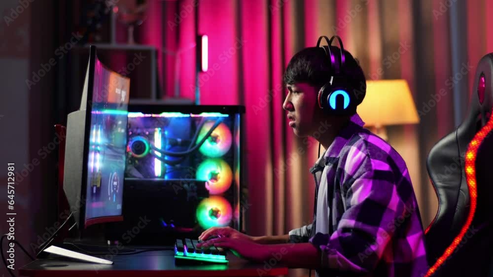 Asian Teen Boy Gamer Lose While Playing Video Game On Computer
