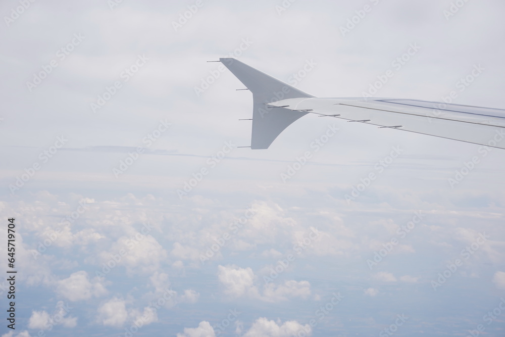Aerial view on cloudy skies from airplane window Aerial view on cloudy skies from airplane window