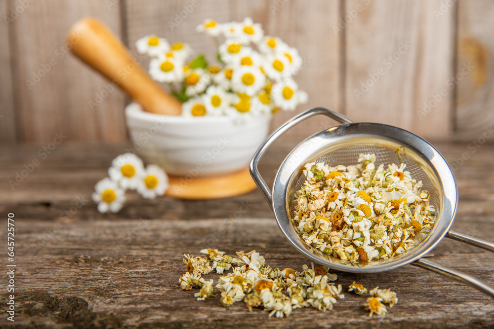 Dry chamomile flowers on a wooden table. Soothing chamomile tea. Herbal drink. flat layout. Space for text.Copy space.Medical prevention and immune concept. Folk alternative medicine. Dry chamomile flowers on a wooden table. Soothing chamomile tea. Herbal drink. flat layout. Space for text.Copy space.Medical prevention and immune concept. Folk alternative medicine.