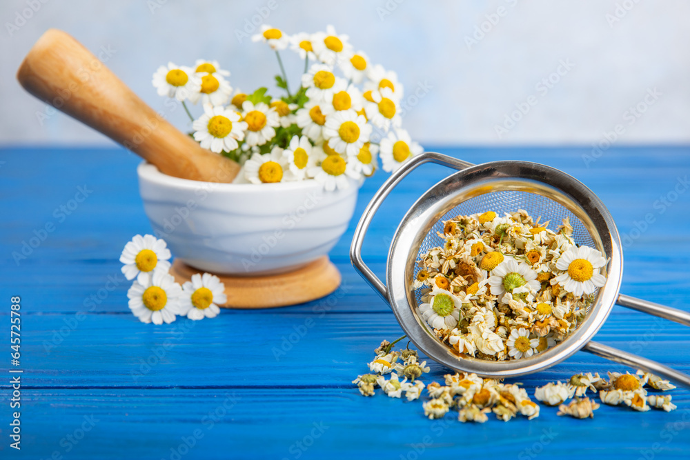 Dry chamomile flowers on a wooden table. Soothing chamomile tea. Herbal drink. flat layout. Space for text.Copy space.Medical prevention and immune concept. Folk alternative medicine. Dry chamomile flowers on a wooden table. Soothing chamomile tea. Herbal drink. flat layout. Space for text.Copy space.Medical prevention and immune concept. Folk alternative medicine.