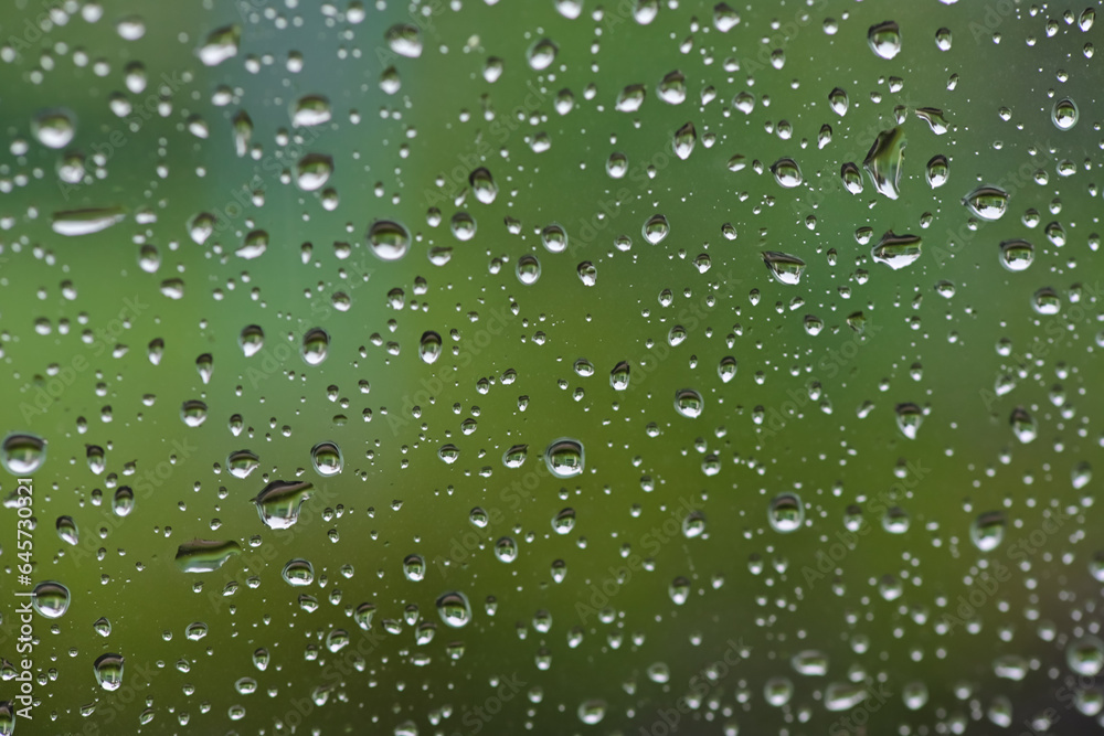 Lots of raindrops on the window. Rainy season concept. Climate change. Wet in rain. Focus on water droplets on window.