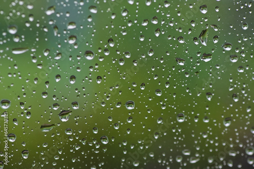 Lots of raindrops on the window. Rainy season concept. Climate change. Wet in rain. Focus on water droplets on window.