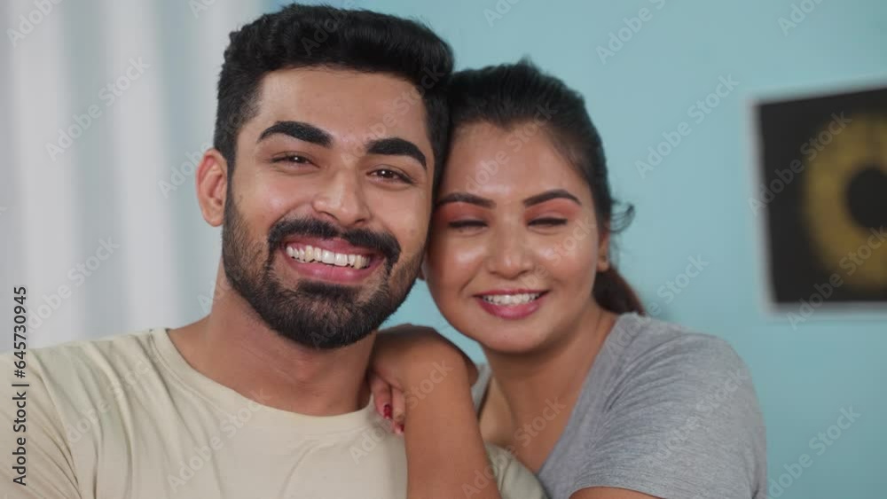 Close up shot of happy smiling indian couples embracing by looking camera at home - concept of affection, family bonding and Loving Connection Close up shot of happy smiling indian couples embracing by looking camera at home - concept of affection, family bonding and Loving Connection