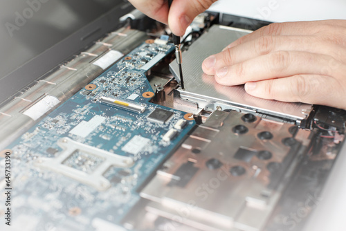 Man repairing laptop, repairman, microcircuits, computer parts
