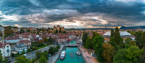 Annecy city center panoramic aerial view over the old town, castle, Thiou river and mountains surrounding the lake. Annecy is known as the Venice of the French Alps