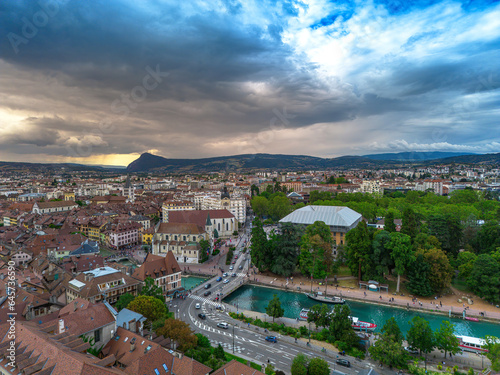 Annecy city center panoramic aerial view over the old town, castle, Thiou river and mountains surrounding the lake. Annecy is known as the Venice of the French Alps
