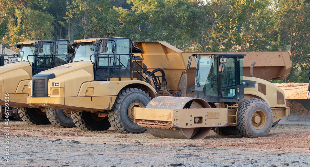 heavy duty construction vehicles in a residential neighborhood, closeup of cab areas heavy duty construction vehicles in a residential neighborhood, closeup of cab areas