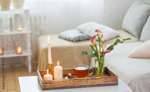 cup of tea and flowers on wooden tray indoor