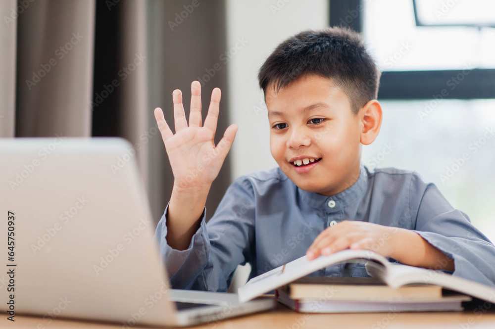 Little Asian boy student using computer laptop learning. Educational concept Social distancing, staying at home, presenting a modern educational way of life. Little Asian boy student using computer laptop learning. Educational concept Social distancing, staying at home, presenting a modern educational way of life.