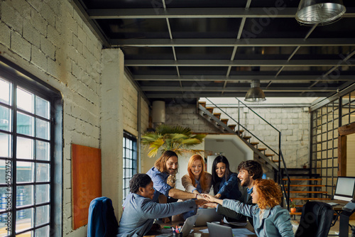 Young and diverse group of designers having a meeting in an office while working in a startup company