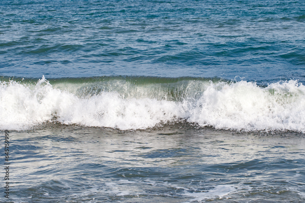Rolling waves on sea, close-up, at clear day, selective focus .
