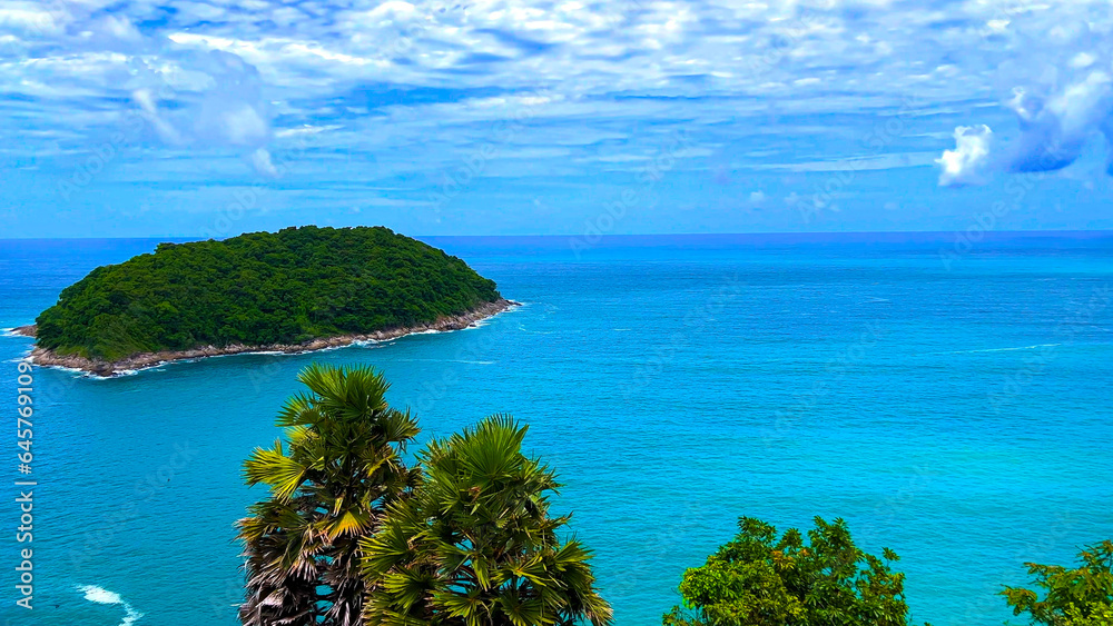 Ya Nui Beach and Nai Harn Beach in Phuket Thailand, turquoise blue waters, lush green mountains colourful skies. Phuket is a tropical island many palms teaming with wildlife and sea fisheries 