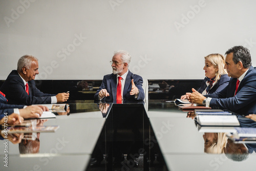 фотографія Business Leaders Sharing Ideas and Strategies in a Large Conference Room