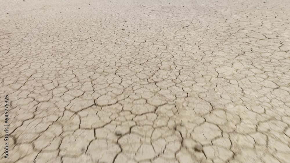 Aerial shot looking down at the cracked surface of a dry lake. Aerial shot looking down at the cracked surface of a dry lake.