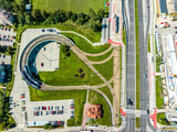 Tramway bidirectional elevated balloon loop on pillars and P+R, Park and Ride parking lot in Kurdwanow peripheral district in Krakow, Poland. Aerial view from above