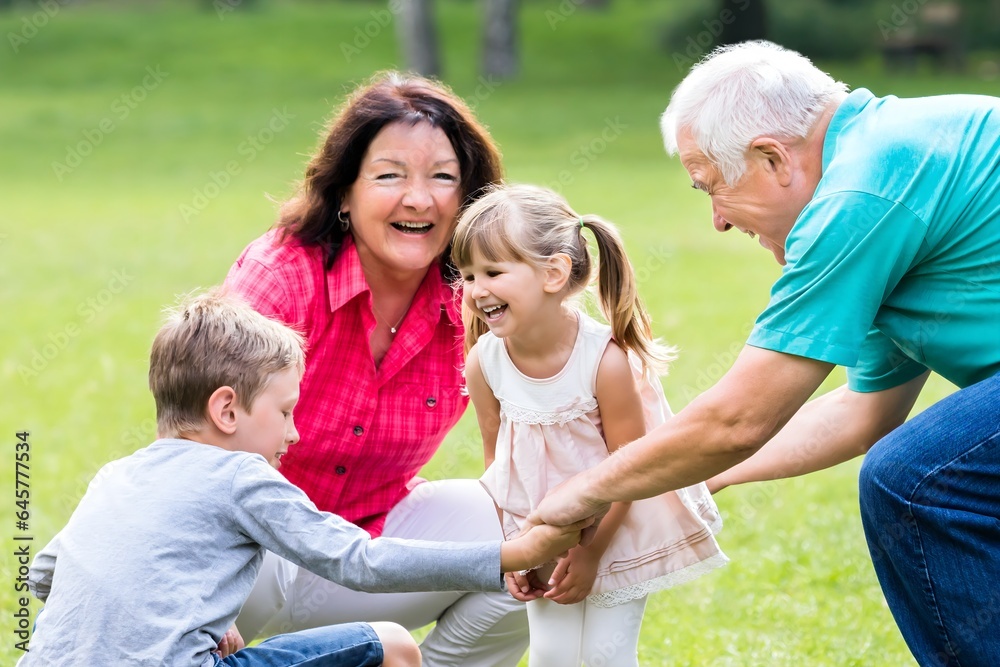 Happy Grandparent And Grandchildren In Park Happy Grandparent And Grandchildren In Park