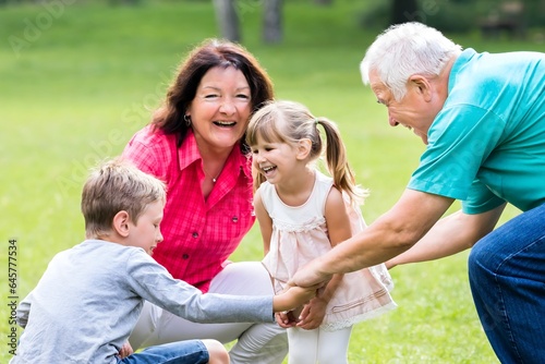 Happy Grandparent And Grandchildren In Park © Andrey Popov